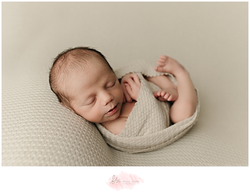 Baby boy sleeping in egg wrap and pose