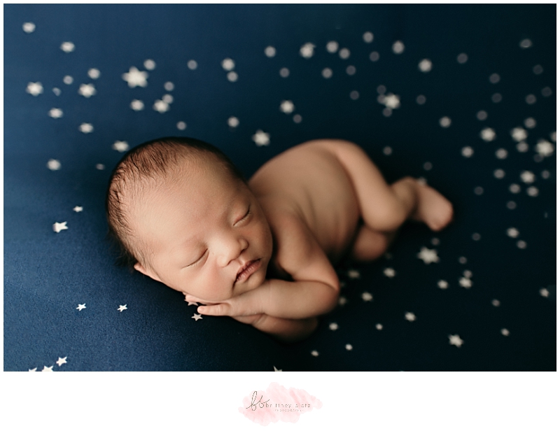 Baby boy side laying on blue star fabric