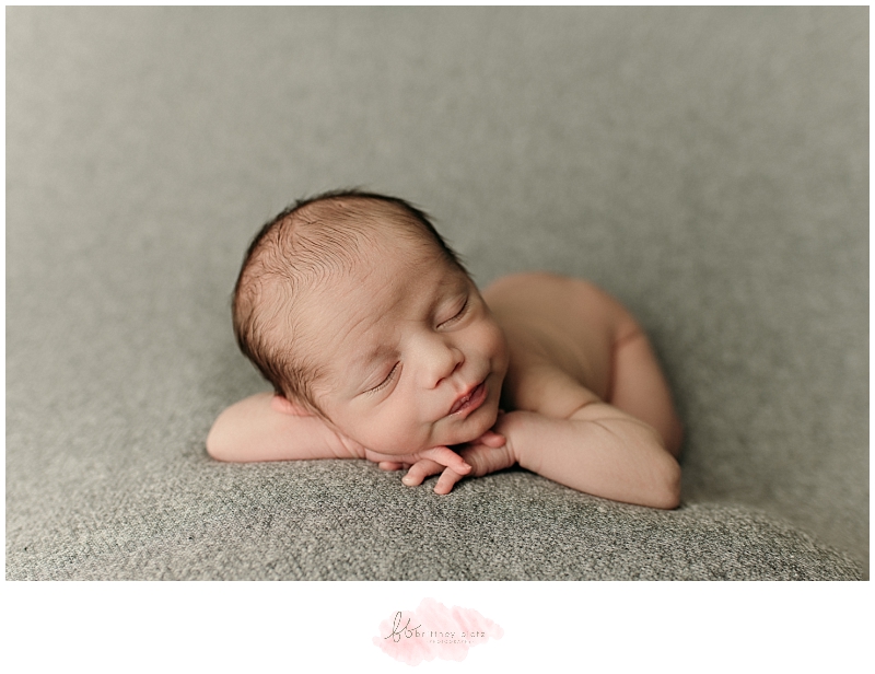 Baby boy sleeping in head on hands pose in Calgary