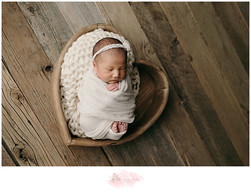 Calgary newborn photo baby girl in wooden heart bowl