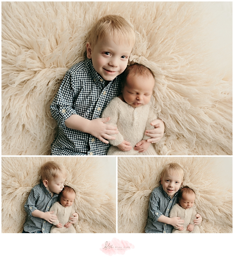 Toddler posing with sleeping baby brother