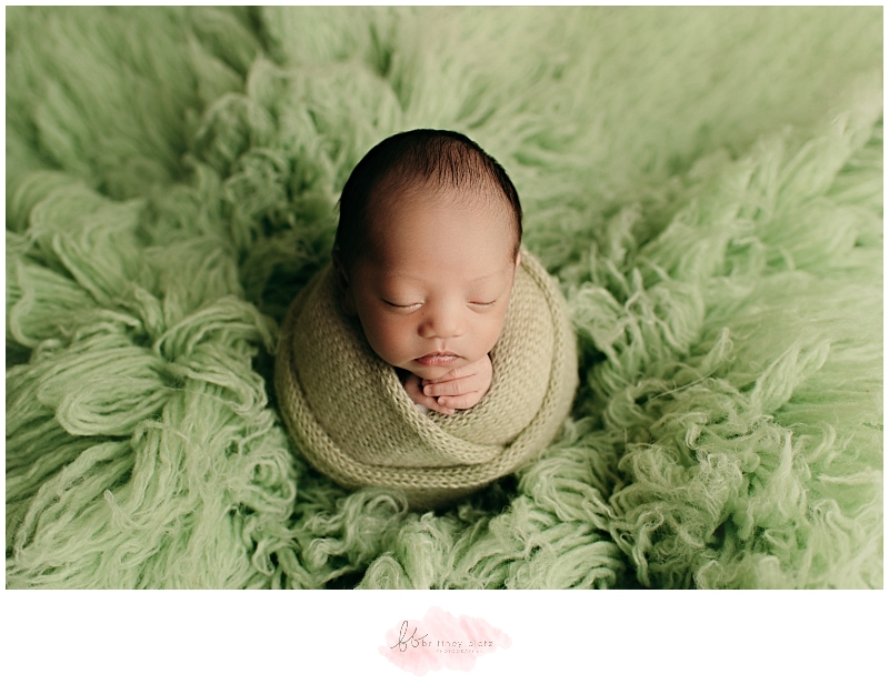 Baby boy wrapped on green floakti