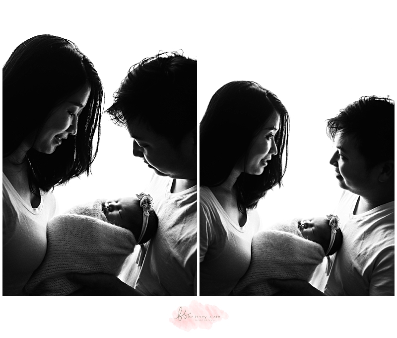 Backlist image of parents holding their newborn baby girl