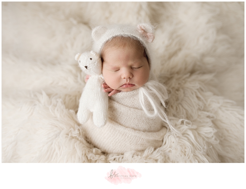 Calgary Newborn Photographer baby girl hugging bear