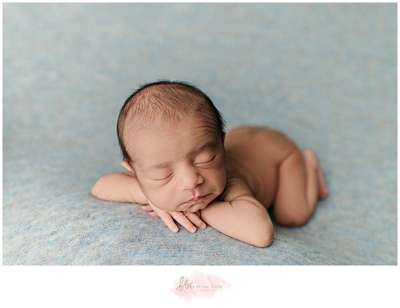 Baby boy forward facing on blue blanket