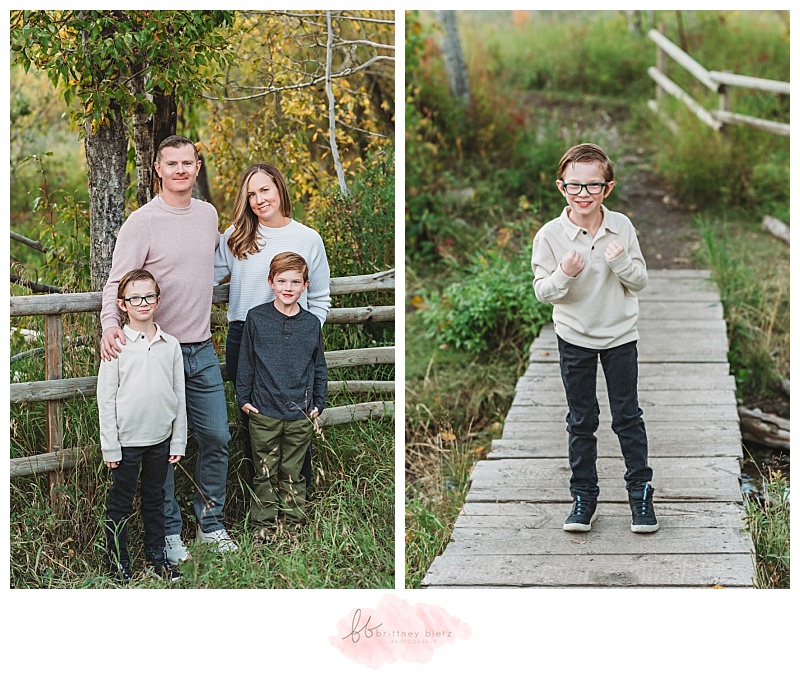 Family of 4 leaning against a fence and boy posing with fists up on a wooden bridge
