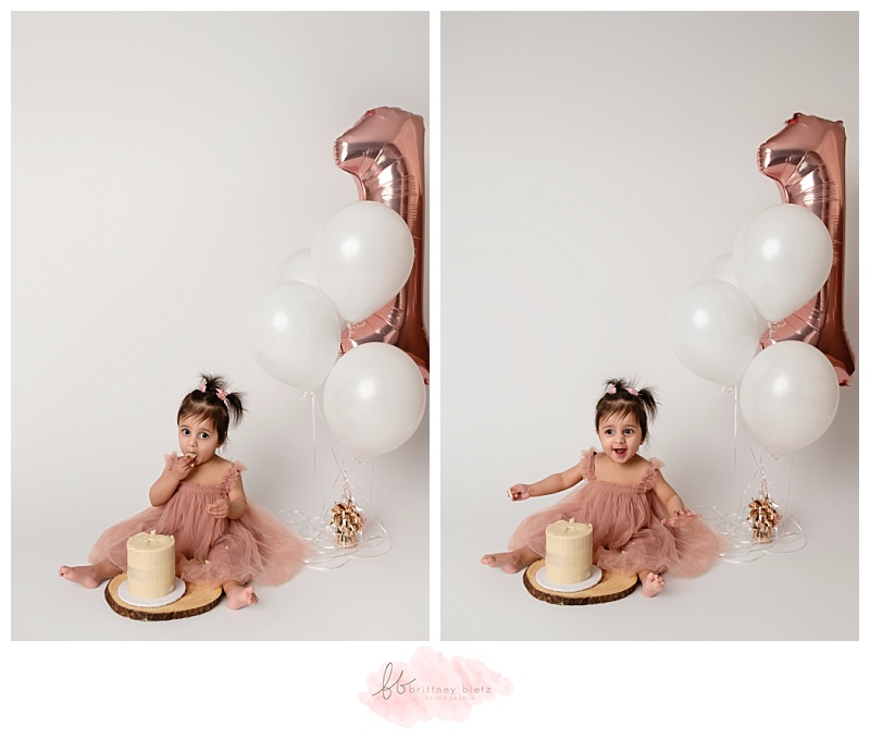 Baby girl reaching for her first taste of a simple white smash cake in a Cochrane cake smash session.