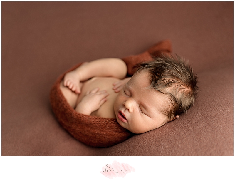 calgary baby boy wrapped in knit copper wrap