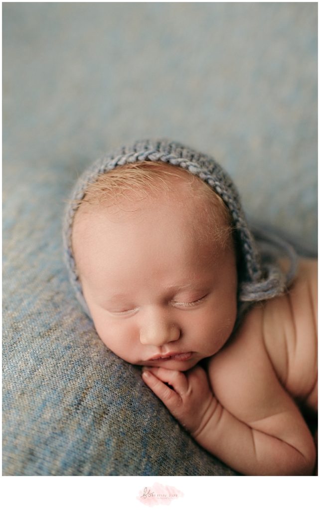 Close up picture of newborn baby boy with blue bonnet