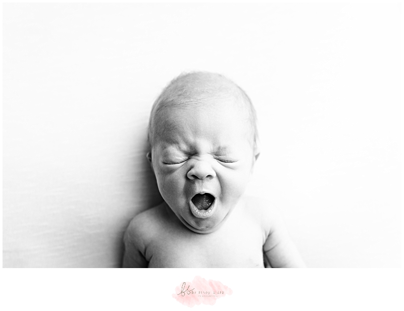 black and white image of newborn yawning